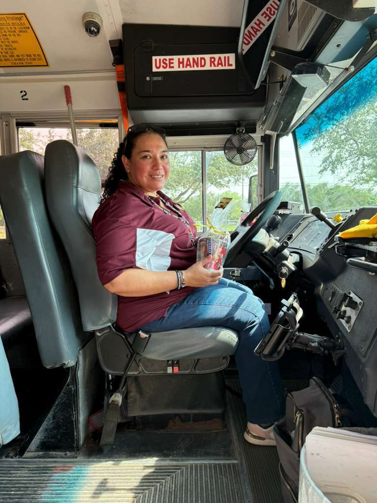 woman in maroon shirt in bus