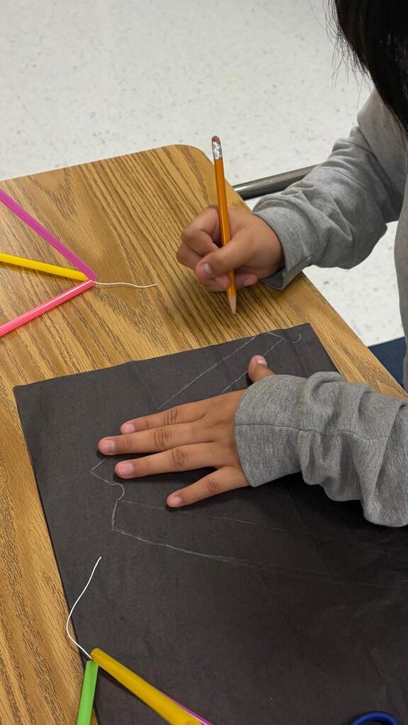 DAEP student traces out materials for a kite