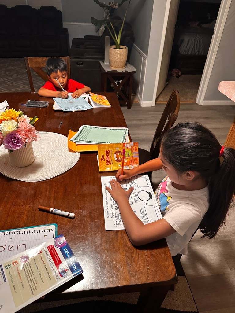 Two students completing work