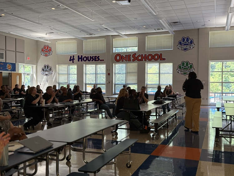 staff listening to Mrs Cook welcome them to the new school year