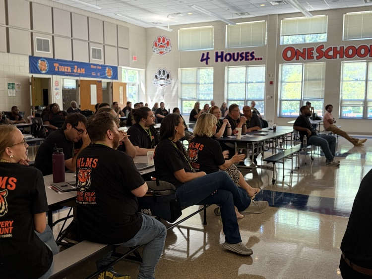 staff listening to Mrs Cook welcome them to the new school year