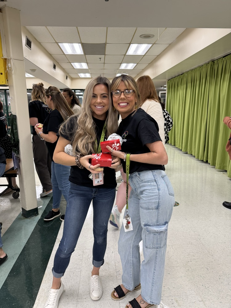 two staff holding food