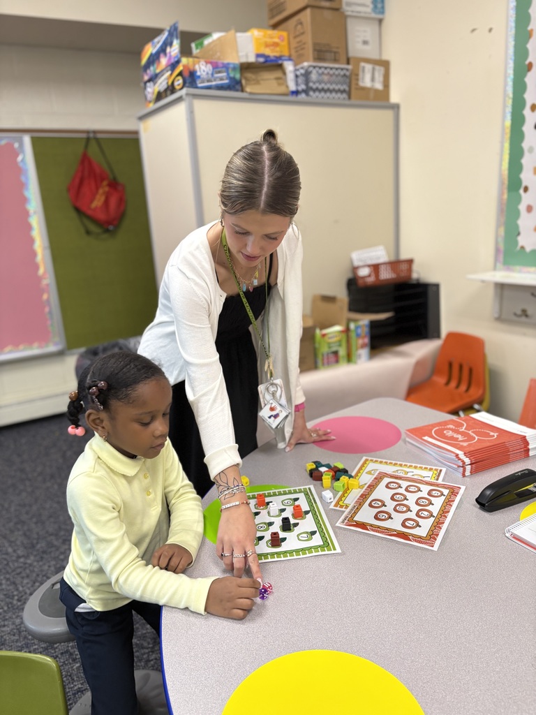 Teacher with student counting ten objects in a set