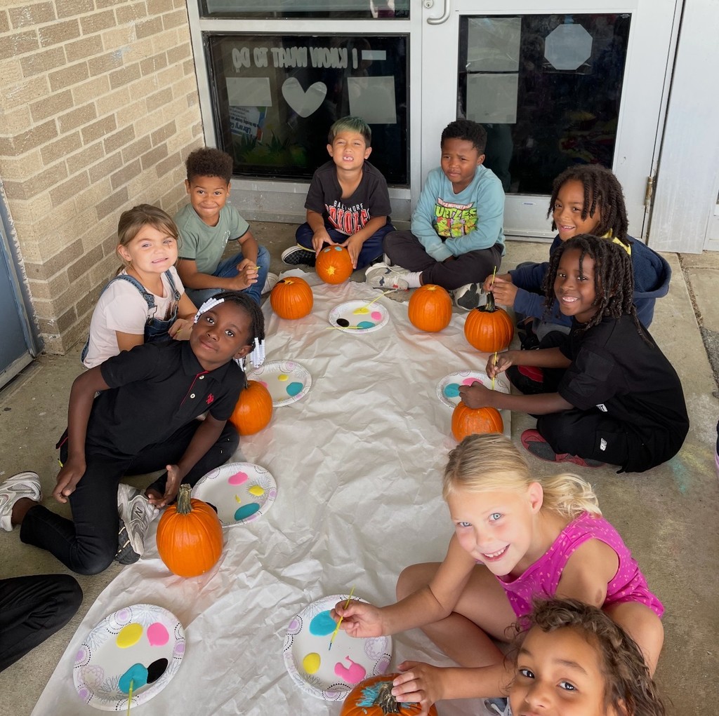 kids painting pumpkin