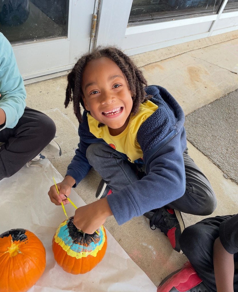 student painting pumkin
