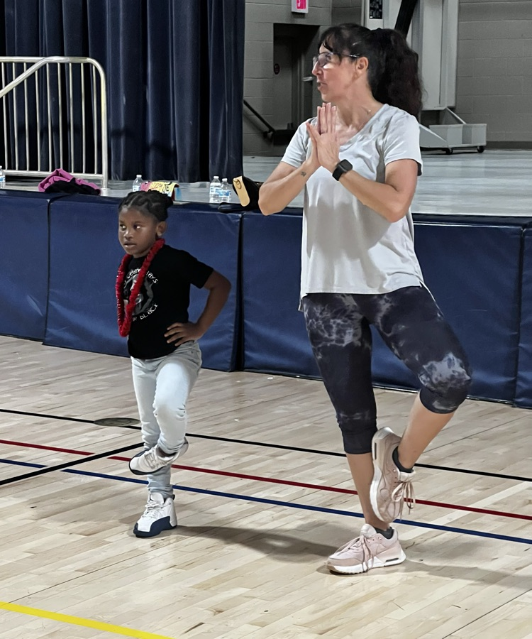 students and families doing yoga