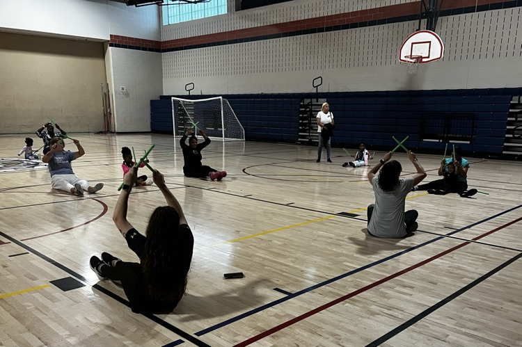 students and families doing yoga