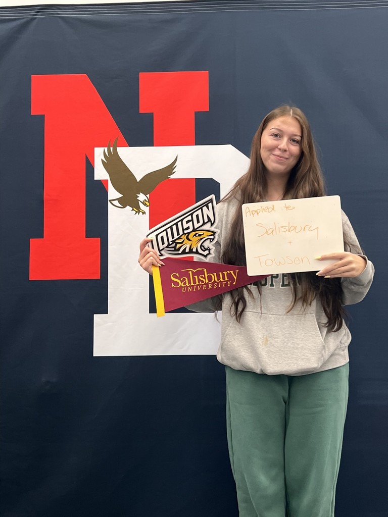 Student holding a college application board