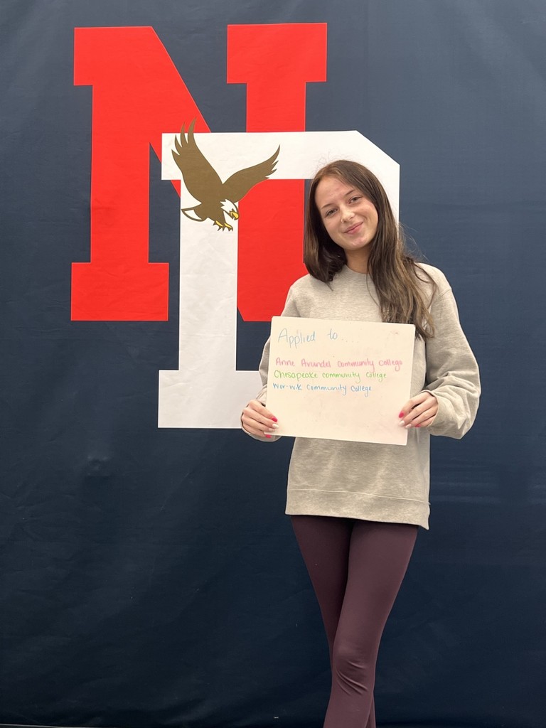 Student holding a college application board