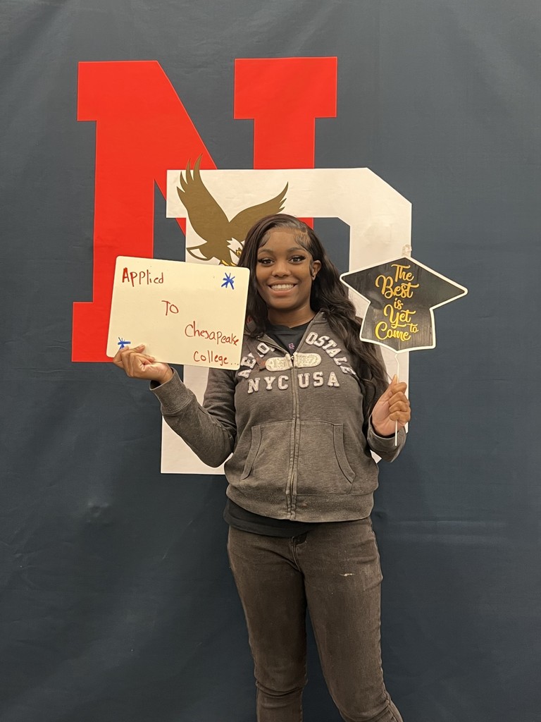 Student holding a college application board