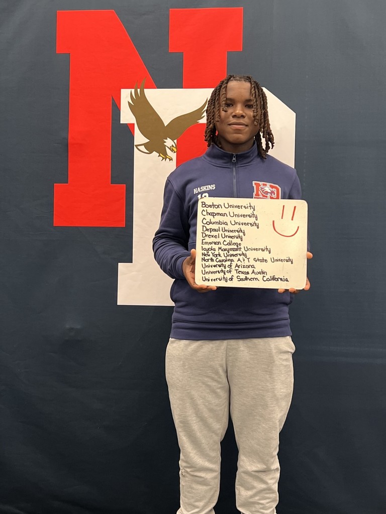 Student holding a college application board