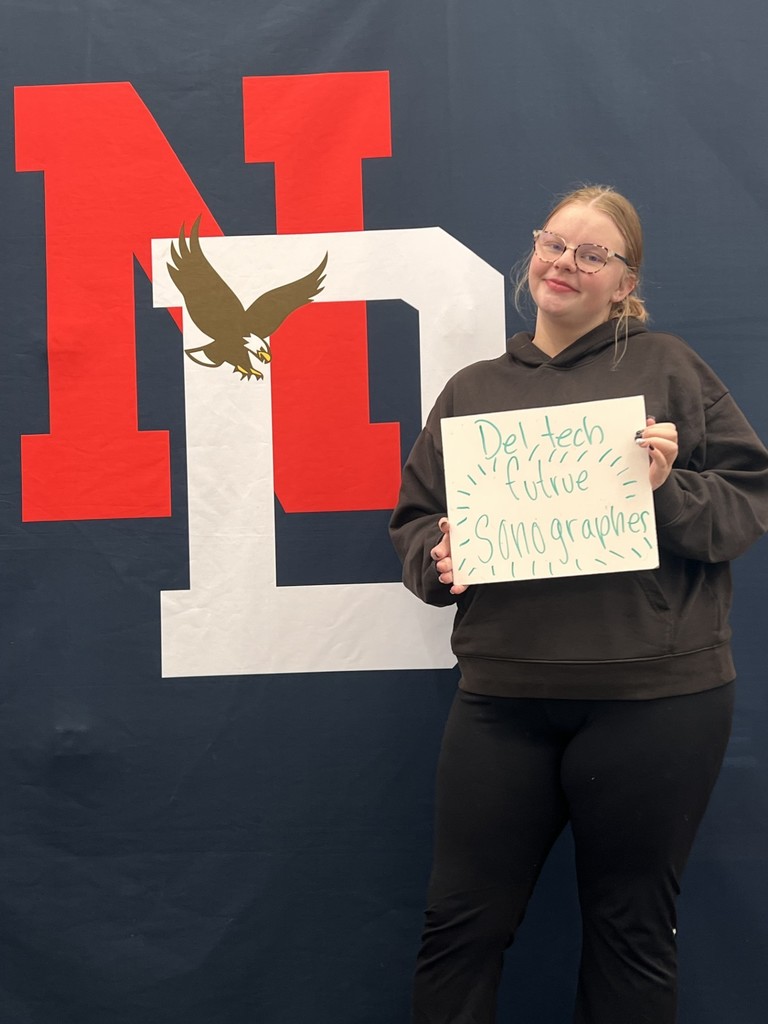 Student holding a college application board