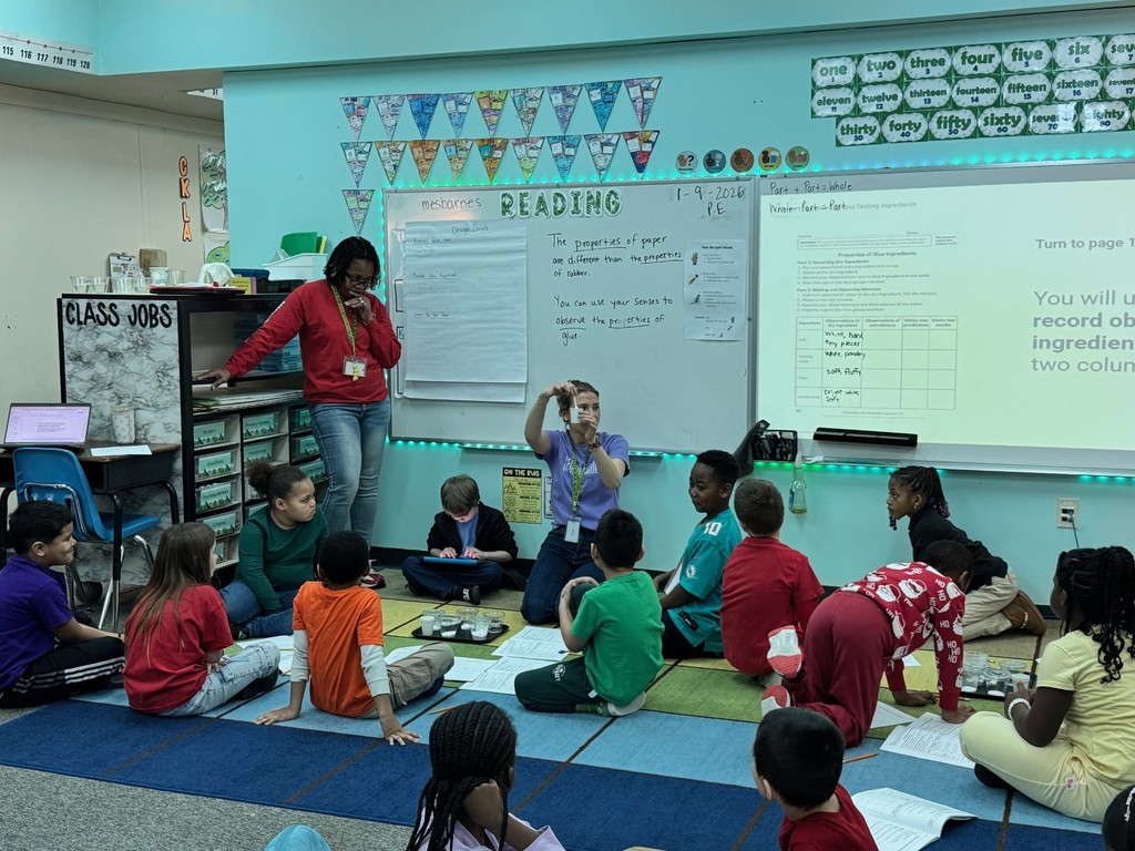 photo of students sitting on the carpet