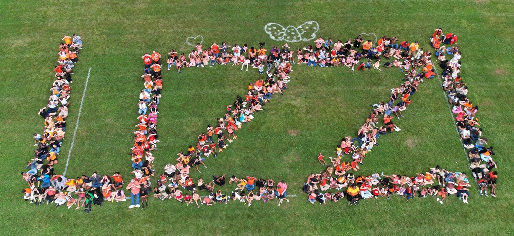 Aerial shot of large group of people spelling 'LIZZI'