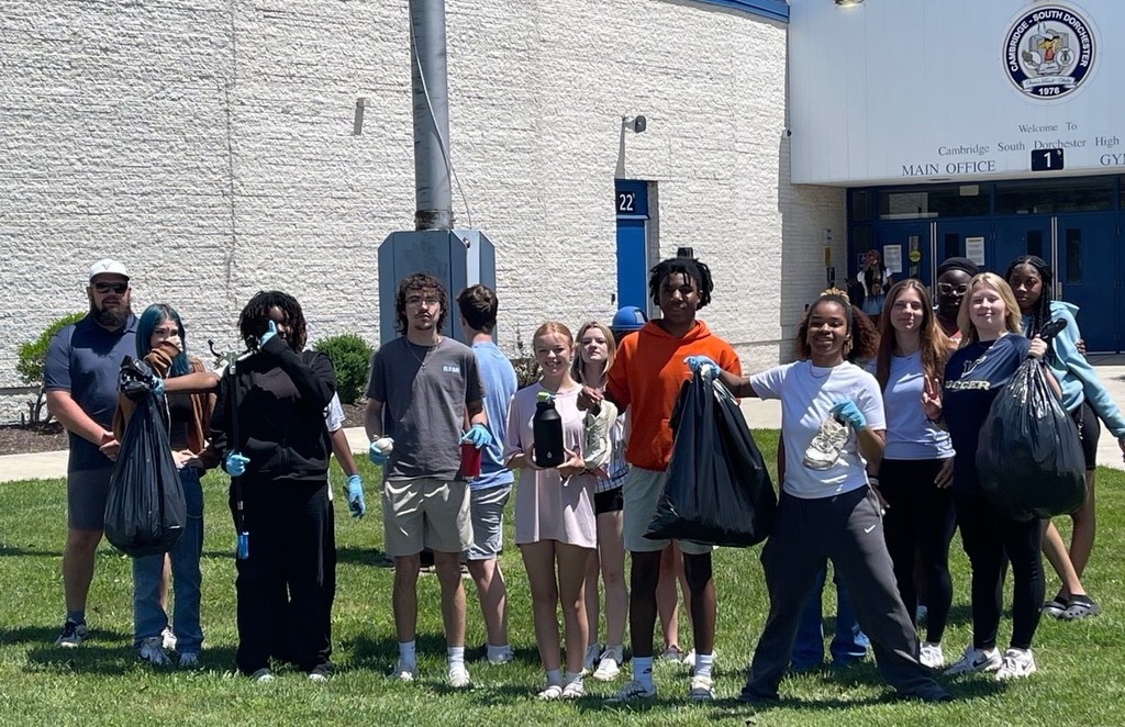 Group of students with cleaning materials