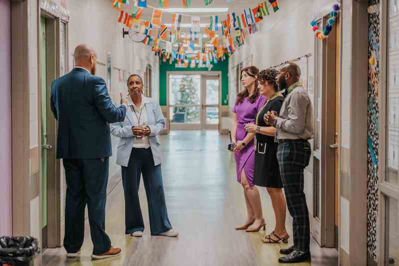 group of adults talking in a hallway