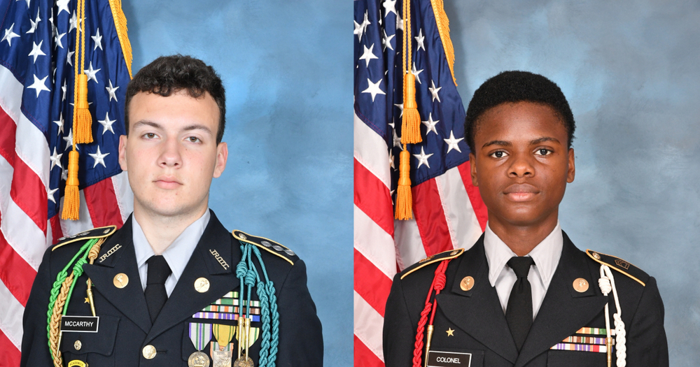 Two Woodland High School JROTC cadets in full dress uniforms pose for official portraits in front of the American flag. The cadet on the left wears a black uniform with multiple ribbons, medals, and cords, and has the nameplate 'McCarthy.' The cadet on the right also wears a black uniform with ribbons and cords, with the nameplate 'Colonel.' Both stand against a blue backdrop with the U.S. flag visible behind them."