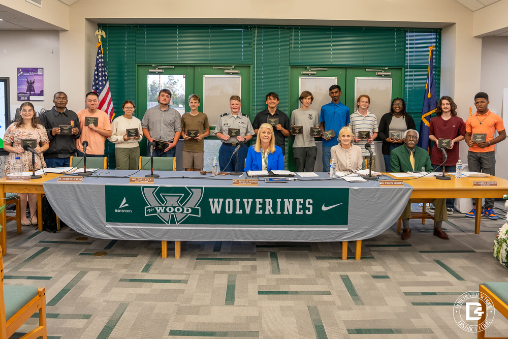 DD4 Board Members with WHS students behind them that scored a 100 on their EOC