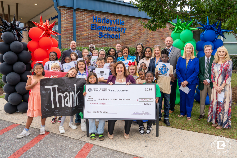 Superintendent weaver with district staff and students
