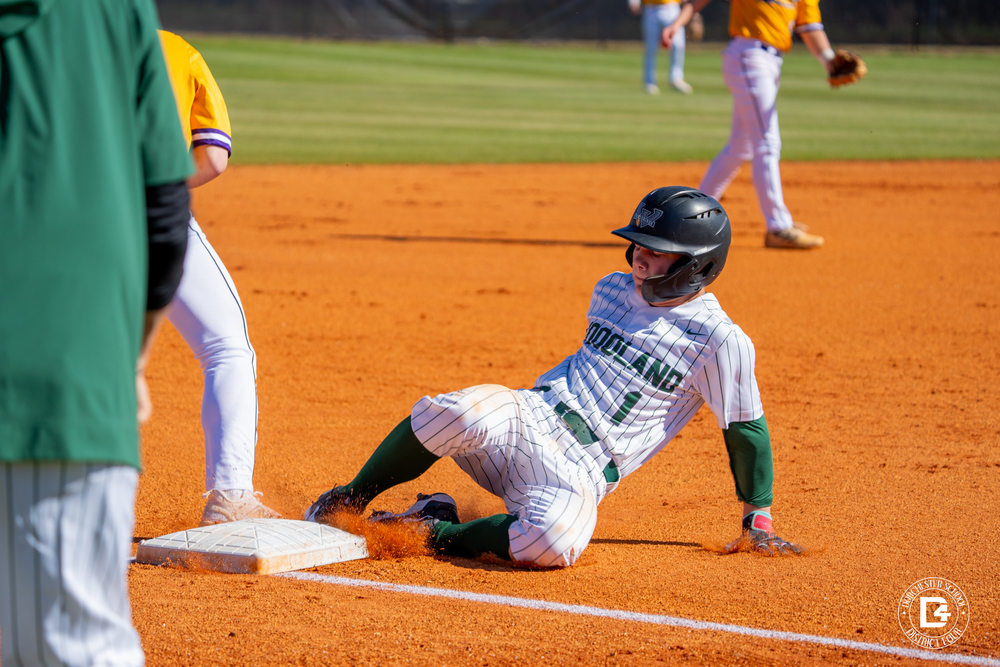Baseball player sliding into 3rd base
