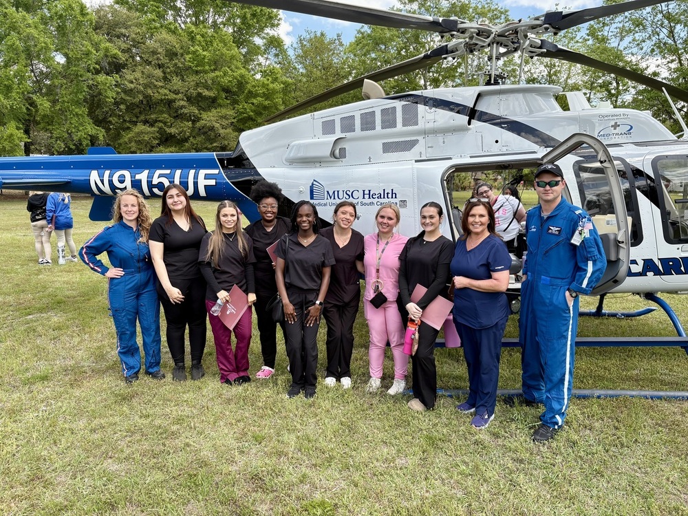 WHS Nursing students standing in front of a medical helicopter posing