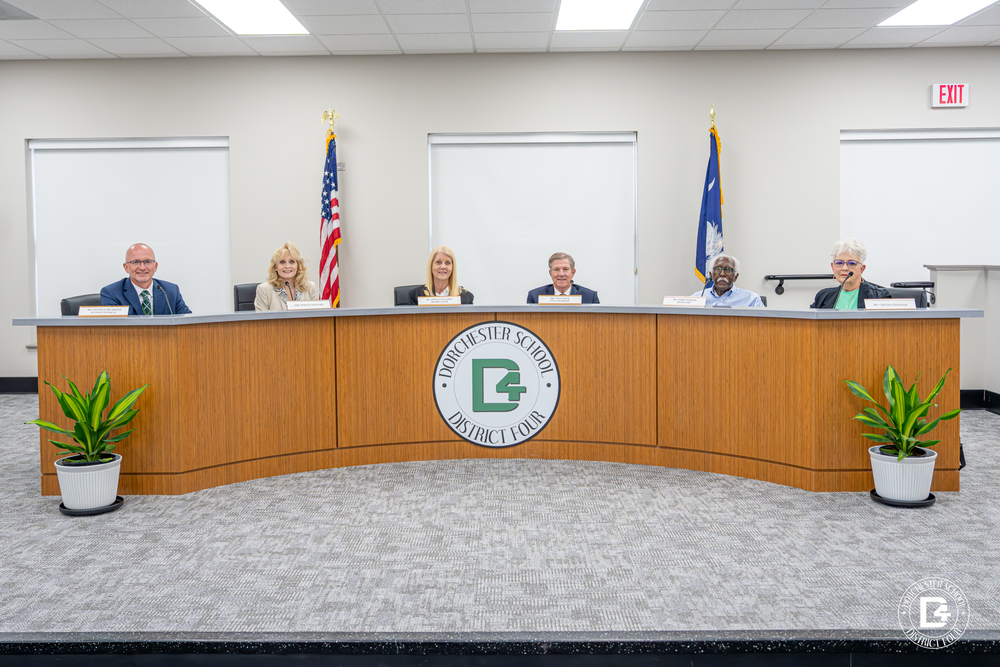Board members sitting at new desk in new space