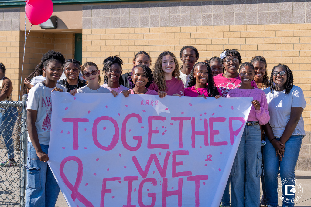 Woodland students holding up "together we fight" banner at the breast cancer walk from Friday