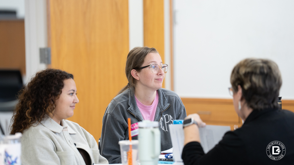 Veteran teachers sit side by side during Dorchester School District Four mentor training, listening and taking notes during a session.