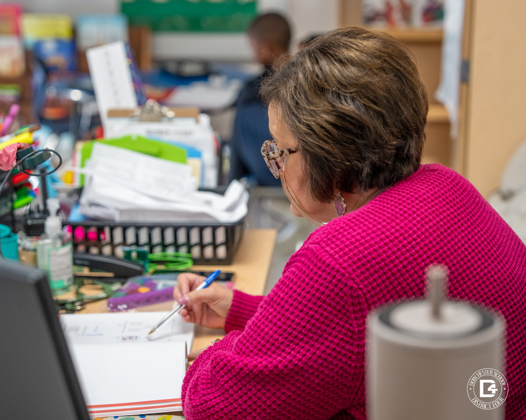 Mrs. Hartzog projects her book onto the screen as students follow along. 