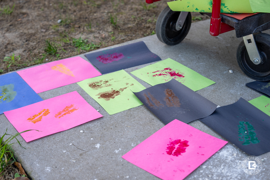 Colorful paper displays fossil impressions created by students during the Dino Dig Day activity in Mrs. Rhode’s 8th grade science class.
