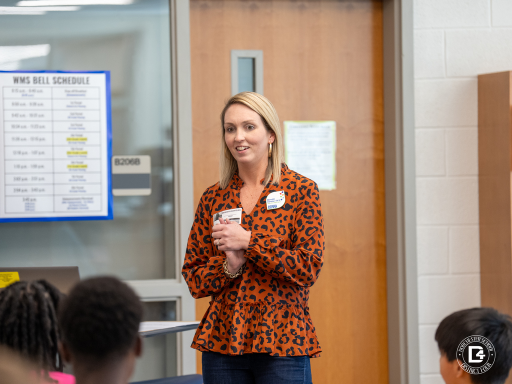 Guest speaker stands at the front of the Woodland Middle School library speaking with students during the ProTeam leadership session.