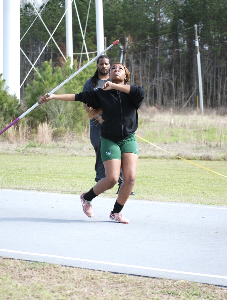 Woodland High School athlete prepares to throw the javelin on the track runway during a track and field meet.