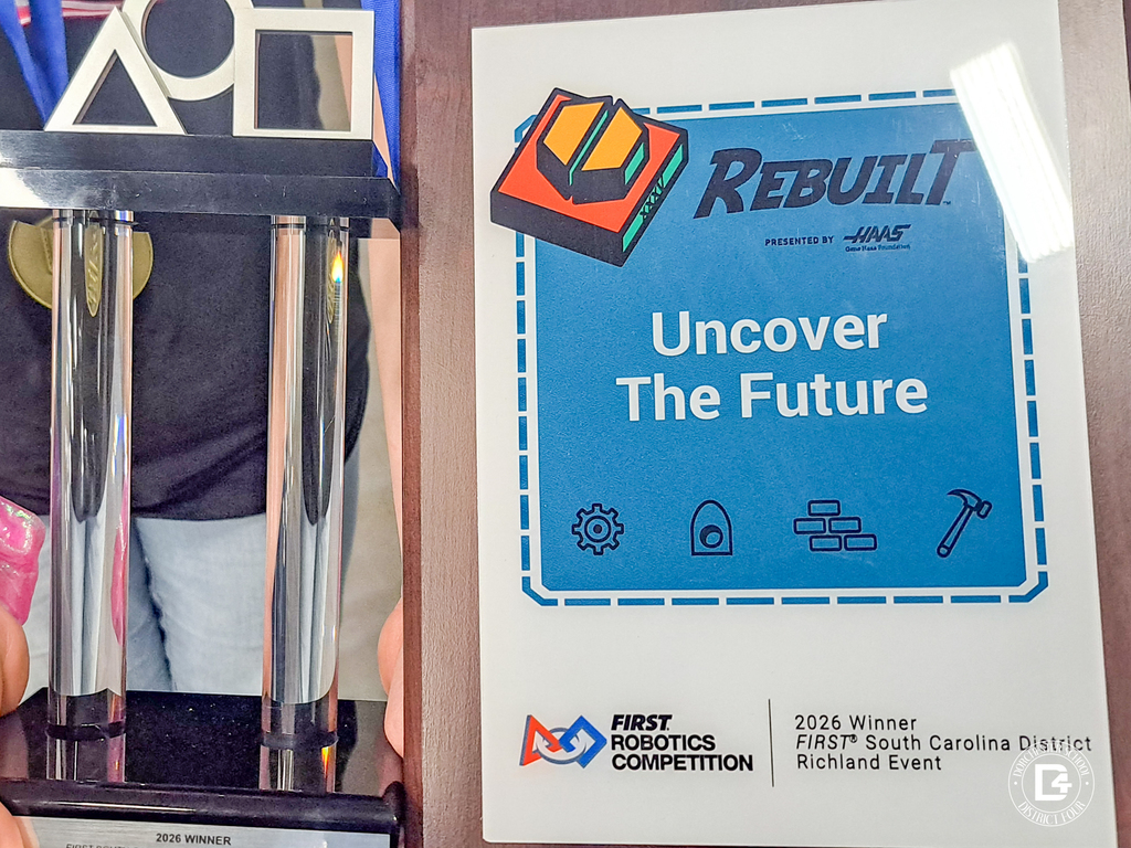 Close-up of a FIRST Robotics Competition trophy and plaque that reads “Uncover The Future,” recognizing the 2026 South Carolina District Richland Event winner.