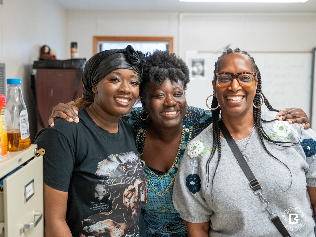 A student and two staff members pose together for a photo backstage during the Quarter 3 attendance celebration event at Dorchester School District Four.