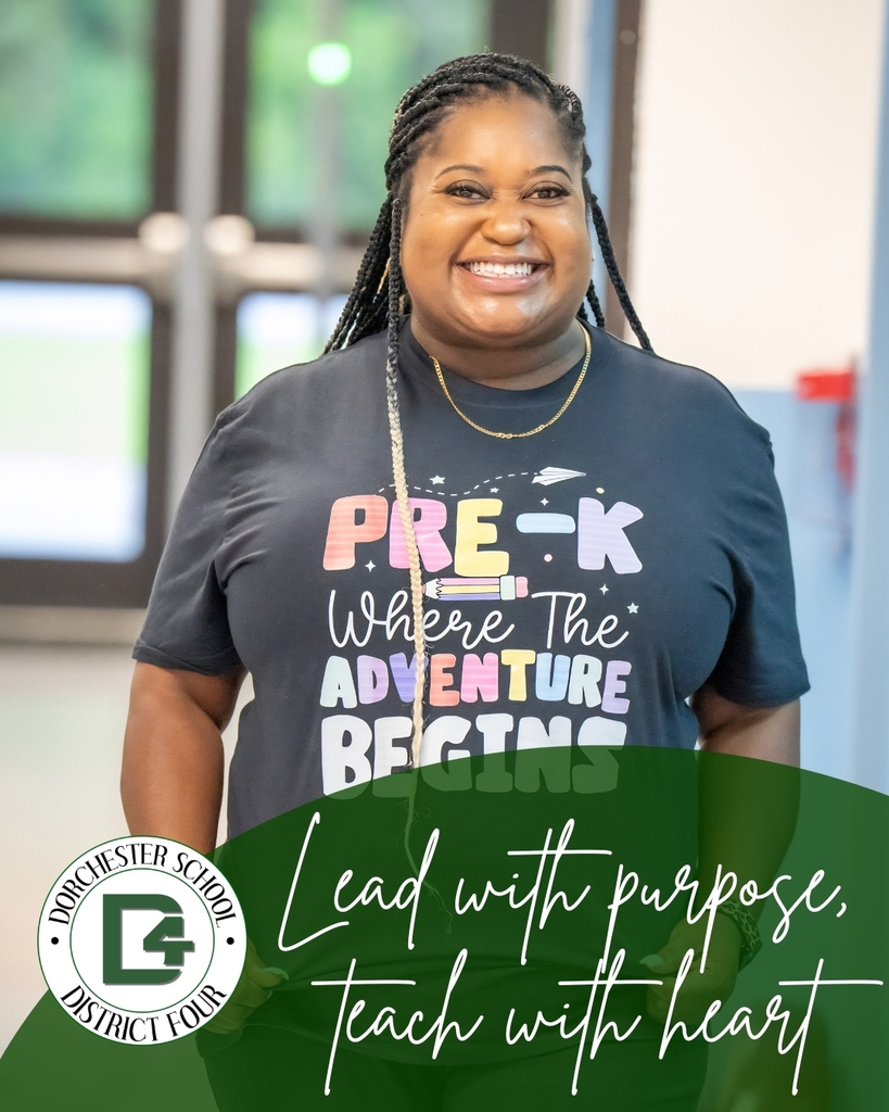 Smiling pre-kindergarten teacher stands inside a school building wearing a “Pre-K Where the Adventure Begins” shirt. The graphic includes the Dorchester School District Four logo and the phrase “Lead with purpose, teach with heart.”