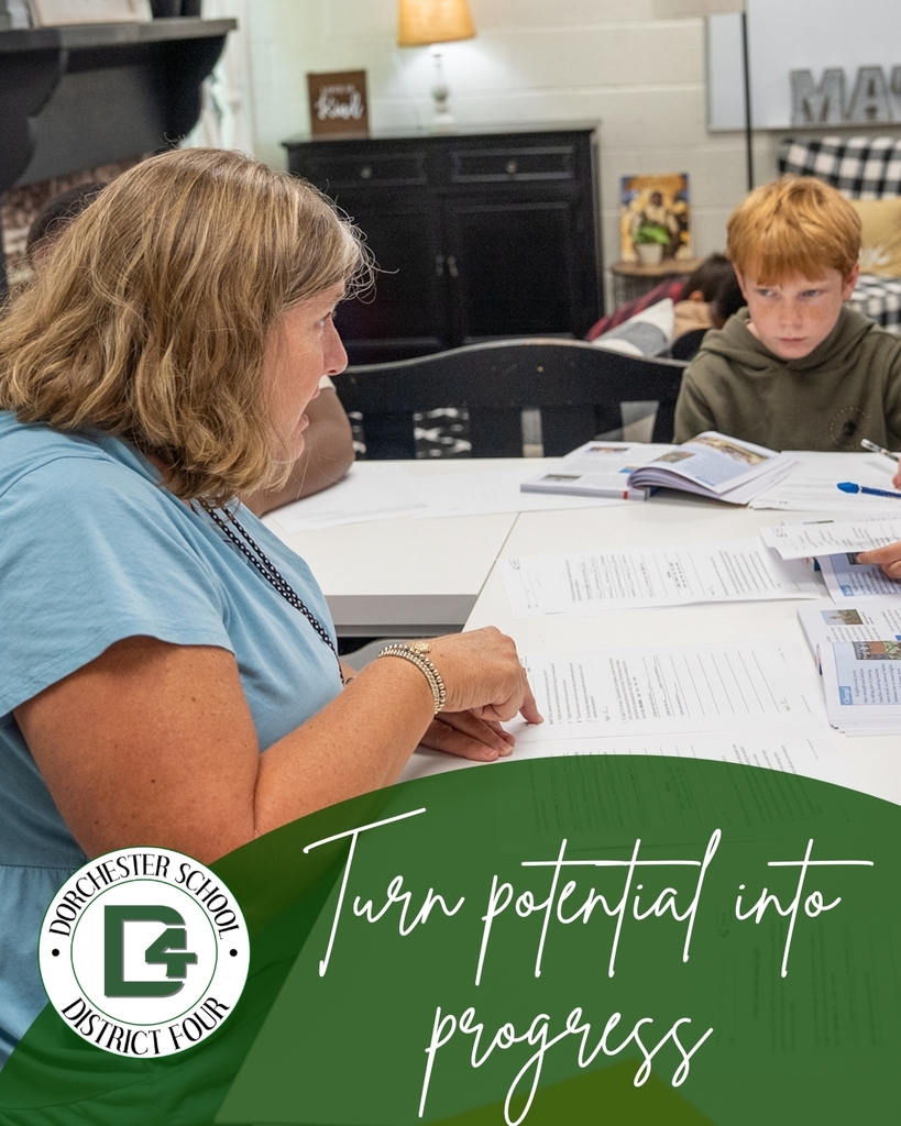 Teacher works with elementary students around a table covered with worksheets and reading materials during a small-group classroom lesson. The graphic includes the Dorchester School District Four logo and the phrase “Turn potential into progress.”