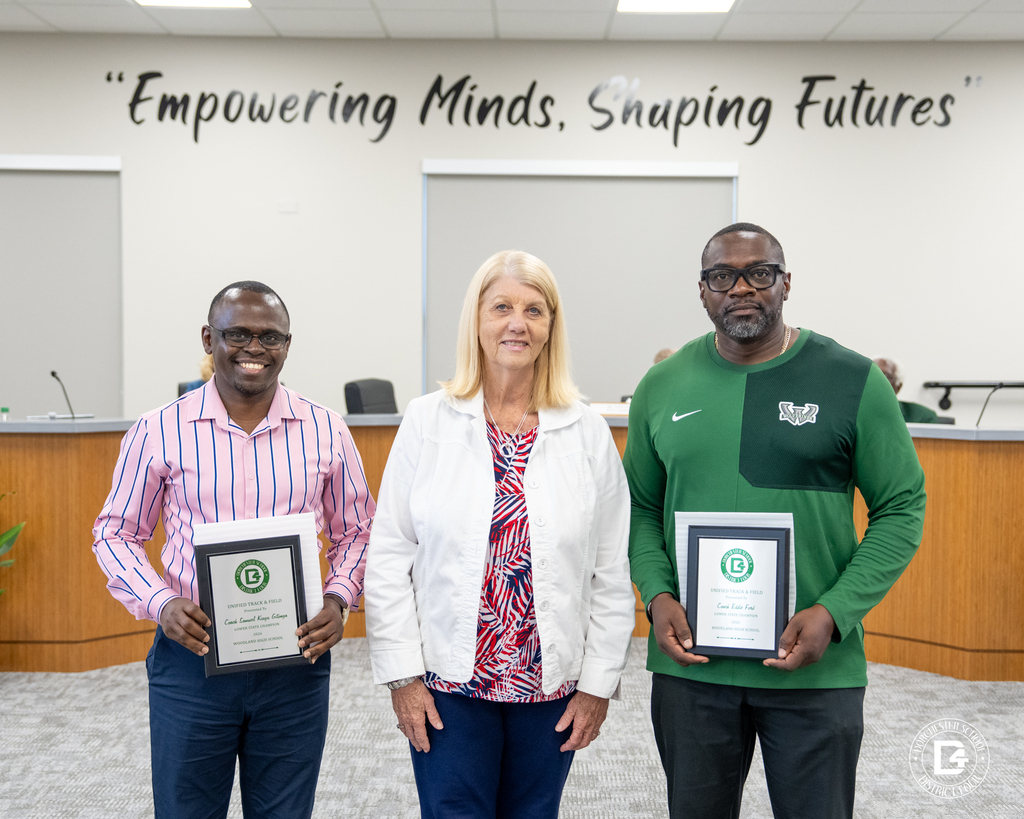 Board Chair and two coaches pose with plaques.
