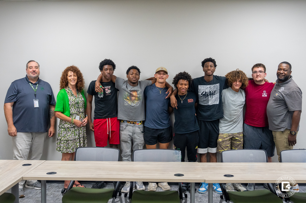 Nine DD4 Summer Student Work Crew members stand with Mr. Harrison and another district staff member after a celebratory lunch marking the end of a summer spent earning paychecks while helping prepare schools for the new school year.