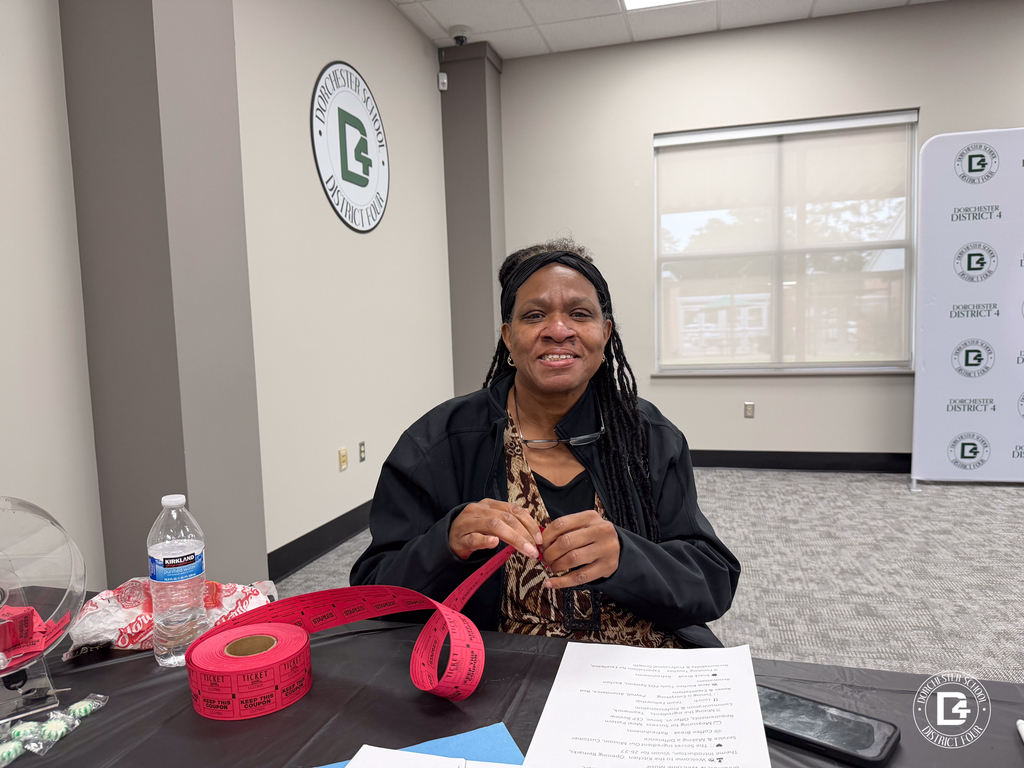 A DD4 Food Services staff member smiles while handing out raffle tickets during the district's Food Services in-service event.
