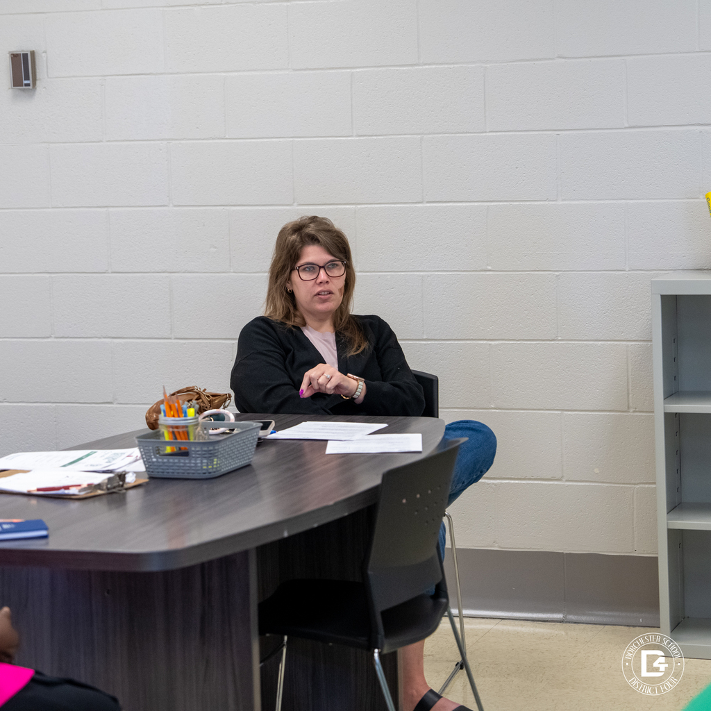 Woman seated at a table during the Dorchester School District Four mentoring program orientation.