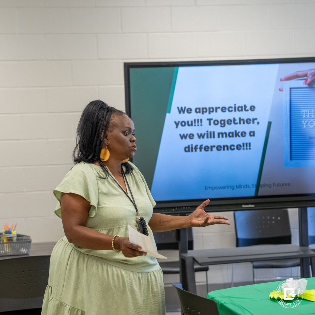 Woman speaks and gestures during the Dorchester School District Four mentoring program orientation.