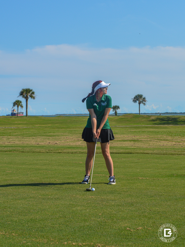 Woodland High School golfer prepares to hit a golf ball on the course.