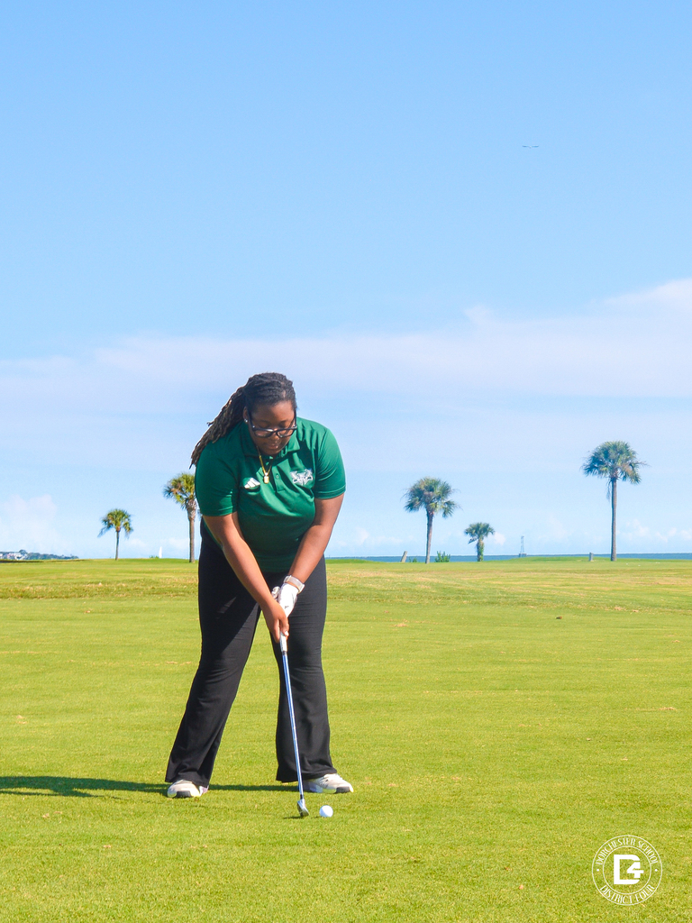 Woodland High School golfer prepares to hit a golf ball on the course.