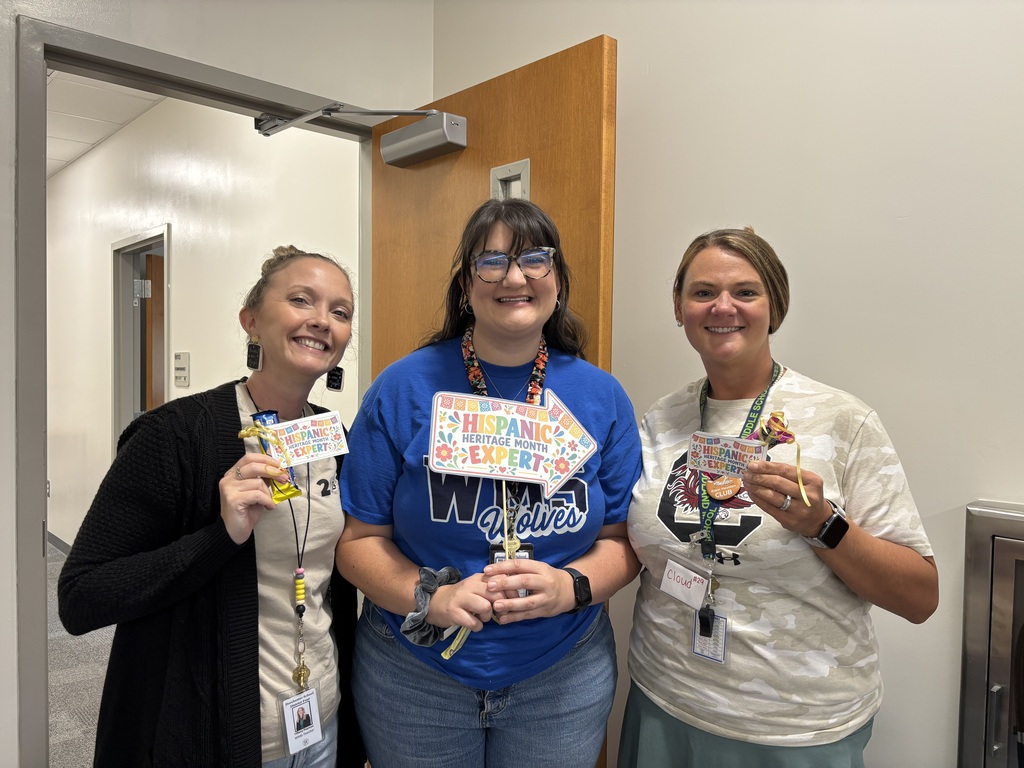 Three WMS staff members celebrate as Hispanic Heritage Month trivia winners.