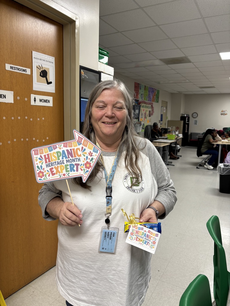 Woodland staff member holds a Hispanic Heritage Month trivia prize.