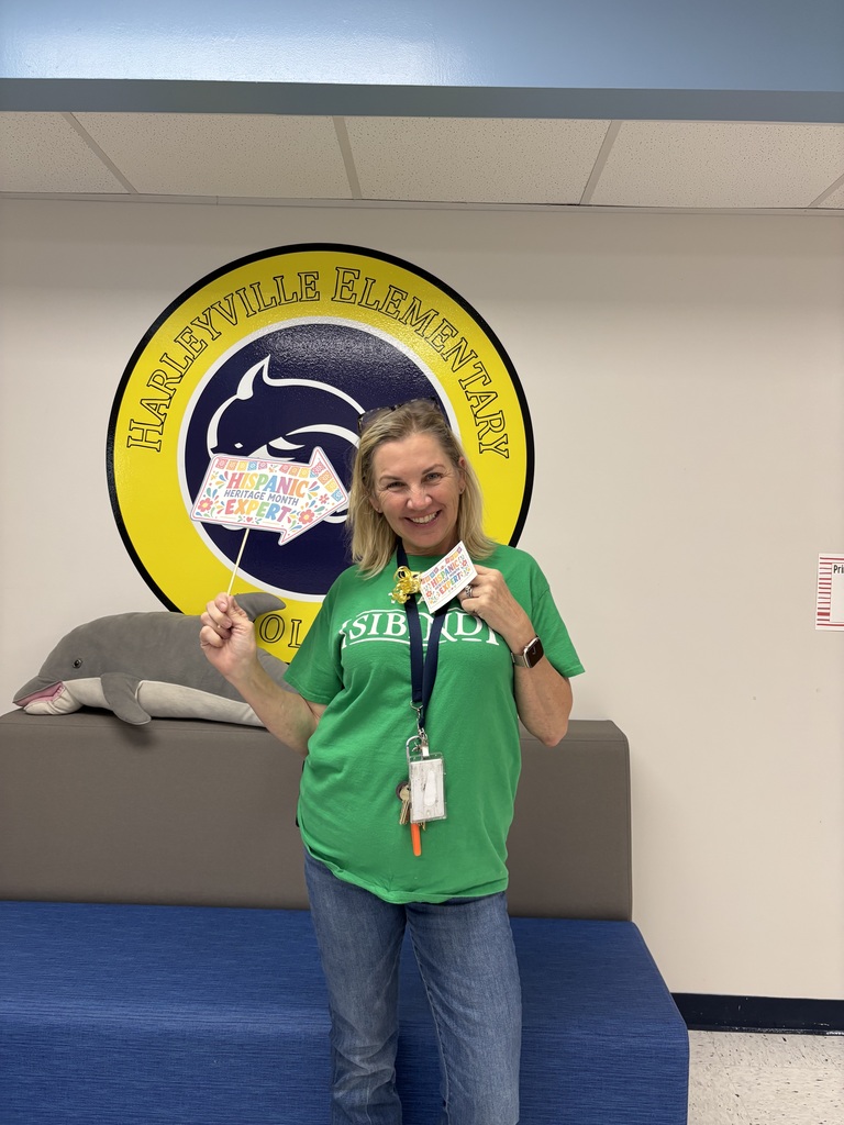 Harleyville Elementary staff member smiles with a Hispanic Heritage Month trivia prize.