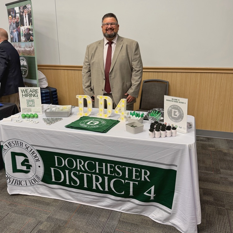 spell relations Director Kevin Lakin standing behind a recruitment table at Clemson university.
