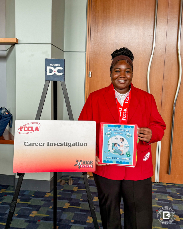 A Woodland High School FCCLA student stands beside her Career Investigation STAR Events display featuring a project on general dentistry during the FCCLA National Leadership Conference in Washington, D.C.
