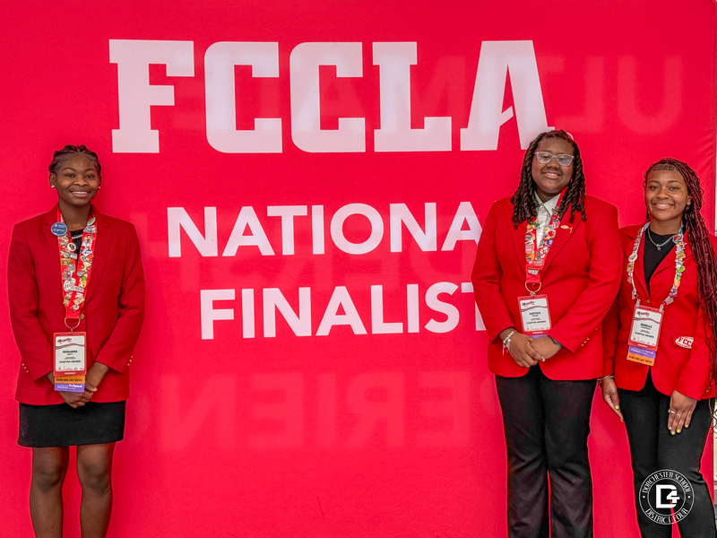 Three Woodland High School FCCLA students pose in front of the FCCLA National Finalists backdrop after advancing to the national finals at the FCCLA National Leadership Conference in Washington, D.C.