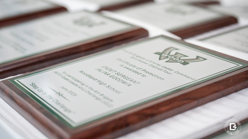 Close-up of a wooden recognition plaque awarded to Cadet Sergeant Jalina Goodwin, engraved with the Woodland High School JROTC insignia and recognition for participating in the JROTC Cadet Leadership Challenge in June 2025.